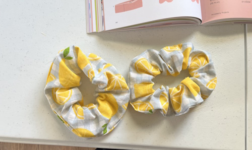 Two scrunchies I made in lemon print fabric one significantly worse than the other